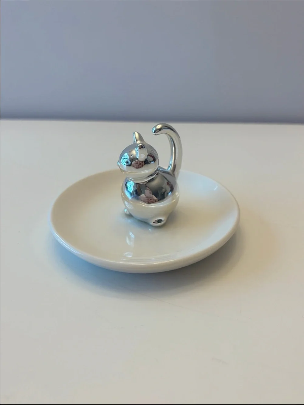 Silver Cat Ring Holder on White Ceramic Dish
